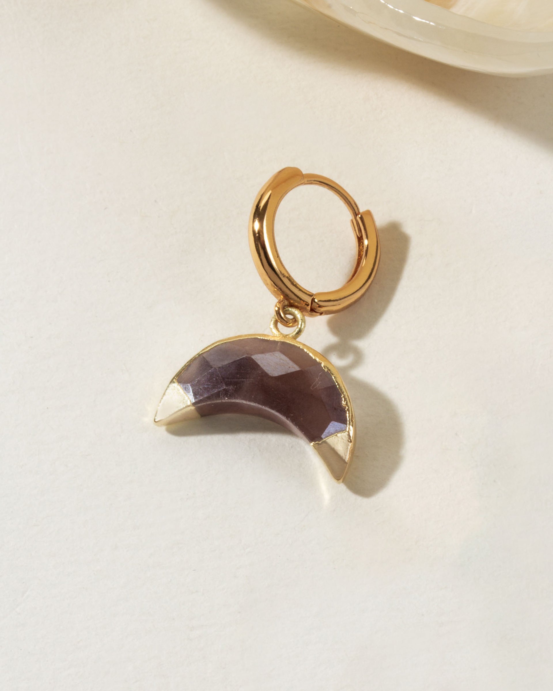 Golden hoop earring with a Coffee Moonstone crescent gemstone.
