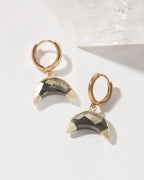 Pair of gold hoop earrings with crescent pyrite gemstones.