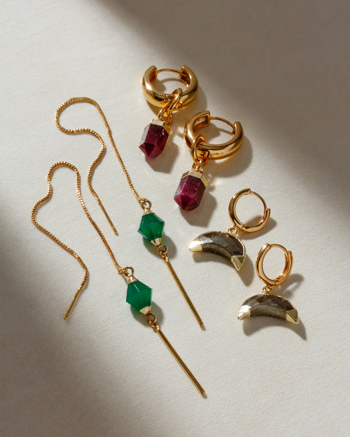 Earrings including green chalcedony threaders and strawberry quartz hoops.