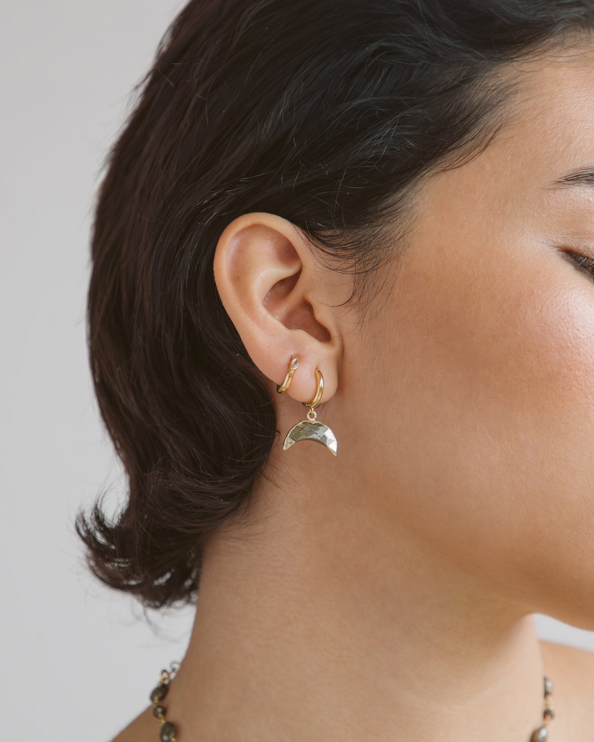 Crescent Horn Huggie Hoop Earring in Pyrite.
