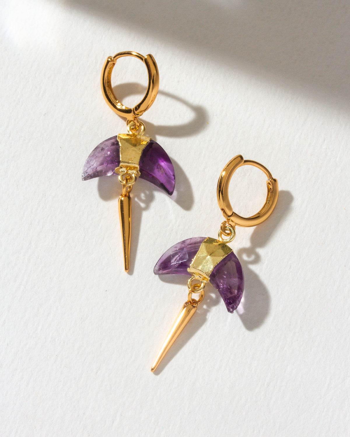 Amethyst Crescent Horn Charm Huggie Hoop Earring with gold hoop and spike, displayed on a white surface.