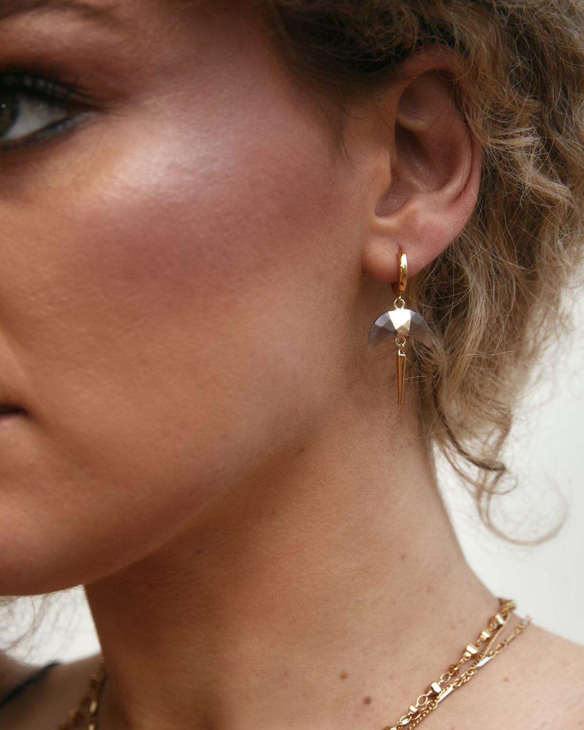Crescent Horn Charm Huggie Hoop Earring with Coffee Moonstone on model.