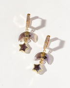 A pair of gold-colored hoop earrings with hexagon shapes encrusted with cz stones, suspended from them are coffee moonstone crescent charm with a gemstone star.