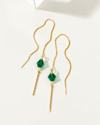 Pendulum threader earring with a faceted green chalcedony stone and gold-colored metal accents.