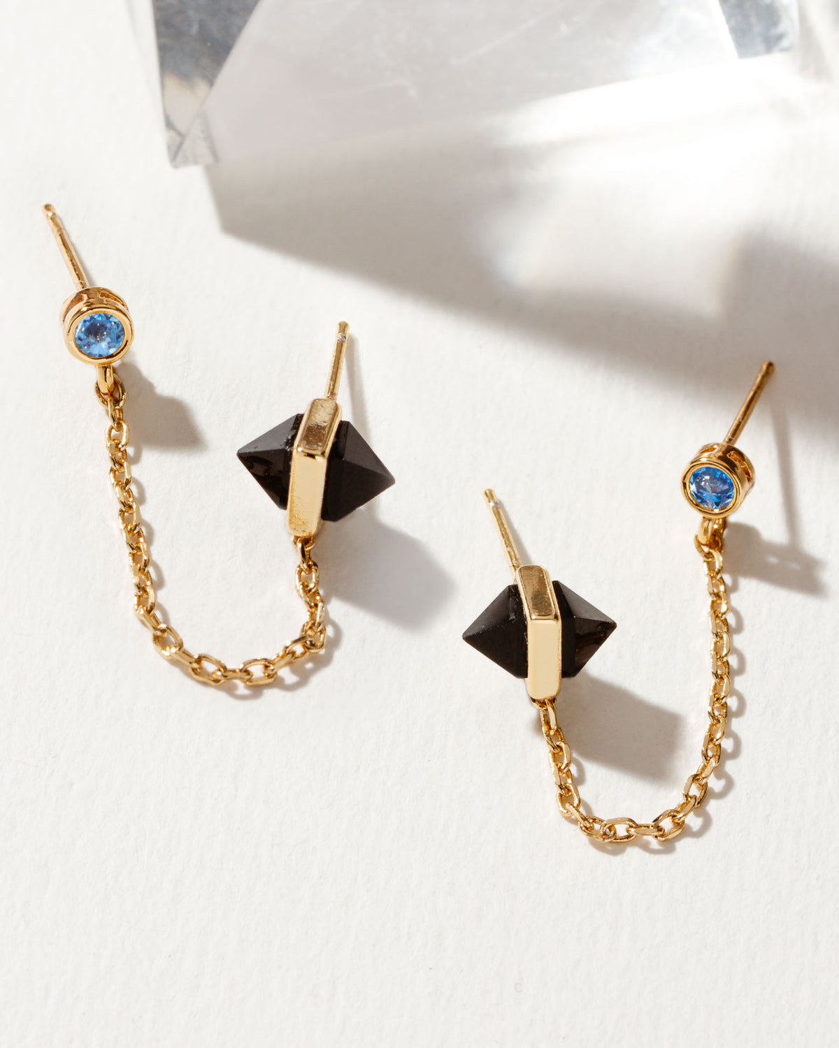 Midnight Serenade double-piercing earrings with crystal stud, onyx pyramids, and gold chain