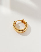 A single gold Huggie Solo Hoop Earring.
