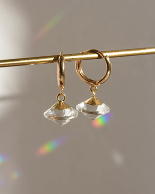 Gold huggie hoop with clear quartz UFO shaped charm