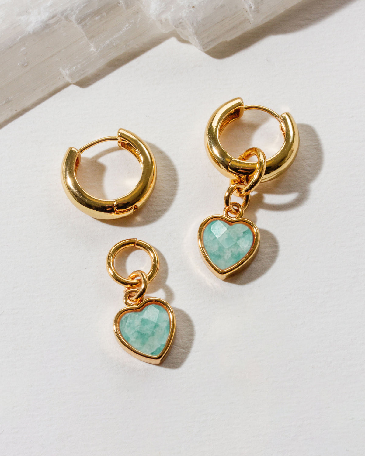 Gold huggie hoop interchangeable earrings with amazonite heart charms.