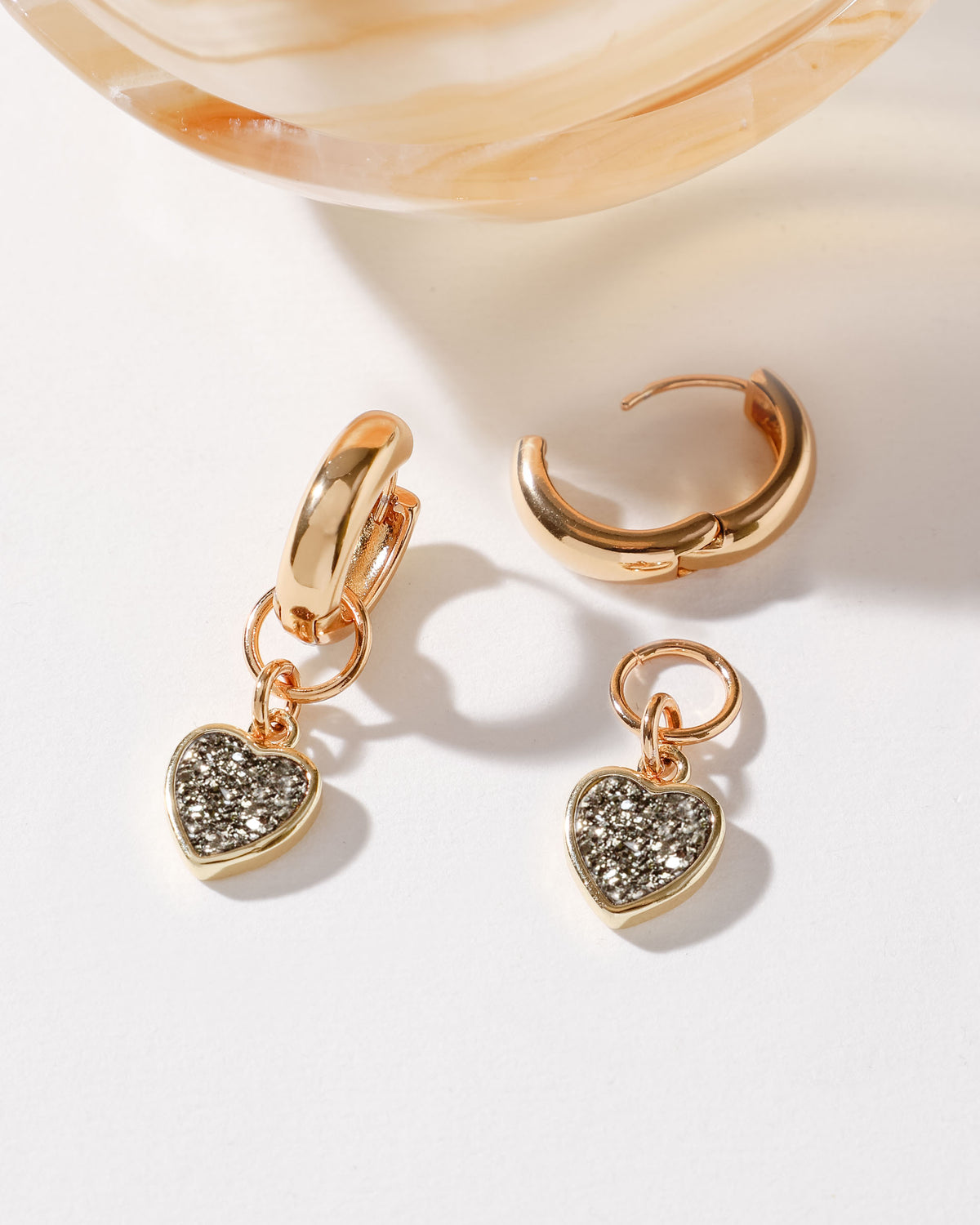 Heart's Accelerated Interchangeable Huggie Hoop Earring Gold with Black Druzy heart charm.