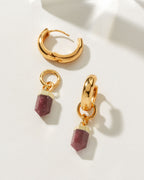Gold huggie hoop earrings with a removable ruby gemstone point charm.
