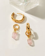 Gold huggie hoop earrings with removable pink Rose Quartz gemstone charms.