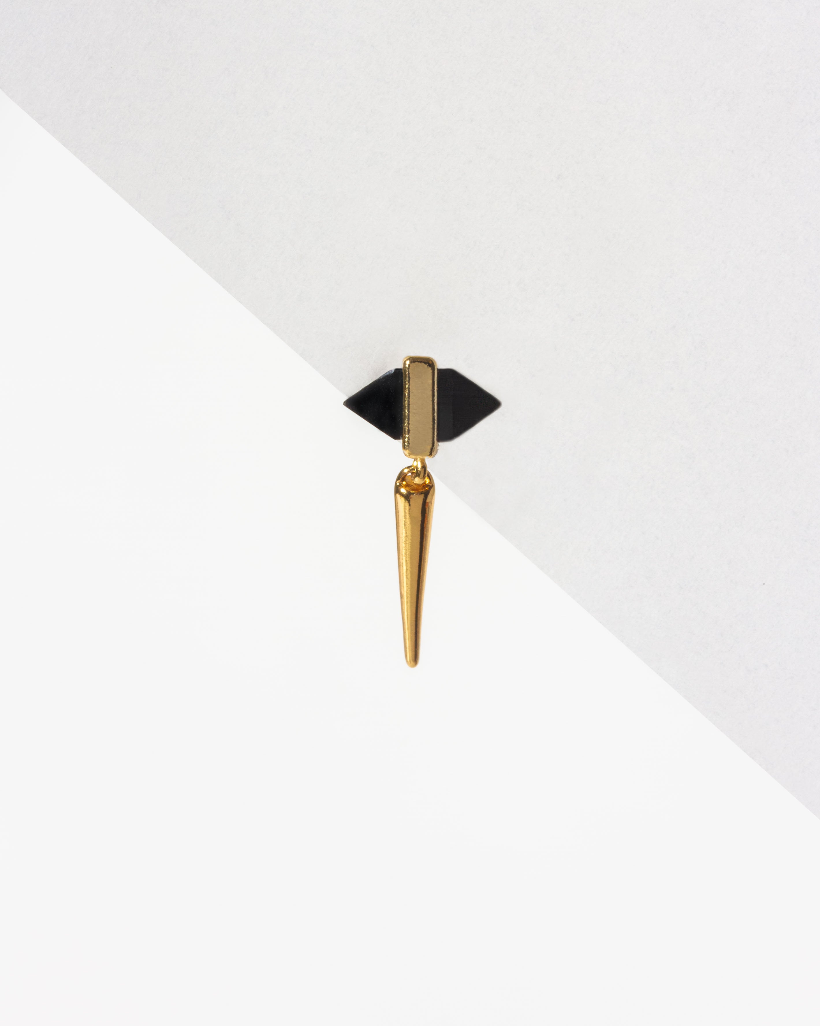 Unity Solo Stud Earring with dual-sided black pyramid stone and gold spike hanging from the bottom.