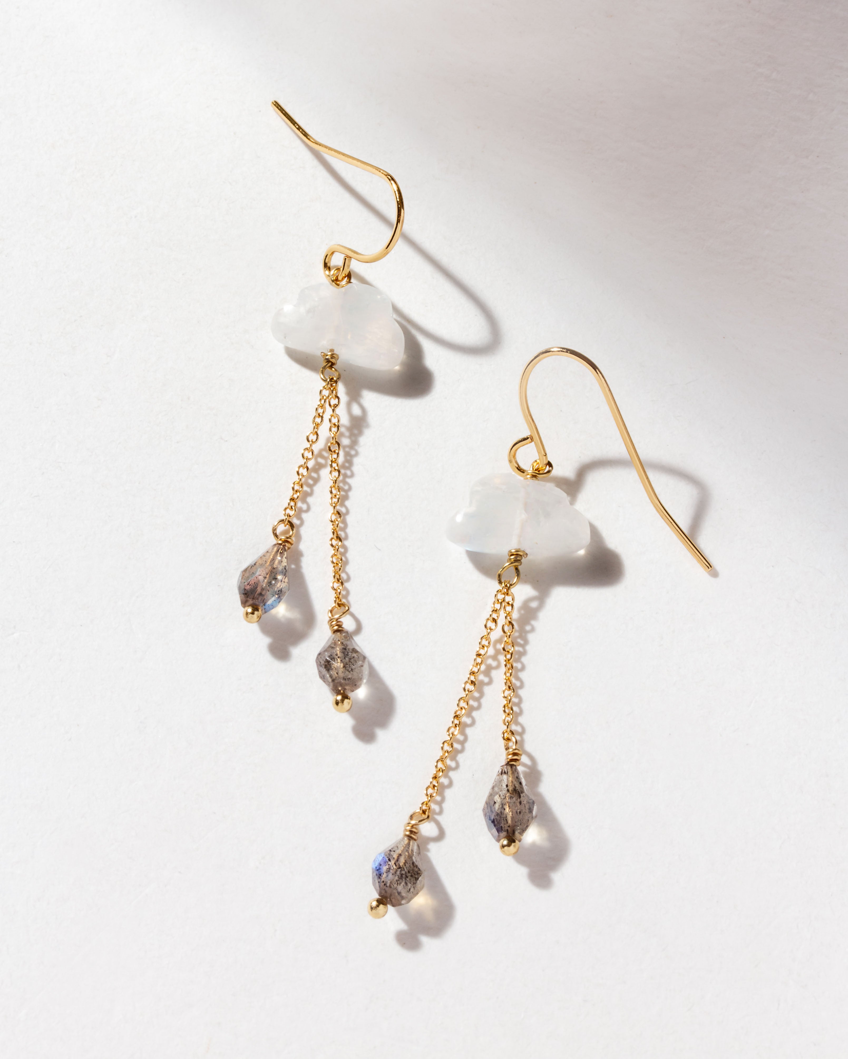 Cloud Nine Gemstone drop earrings in Moonstone, with gold chains and labradorite stones dangling.