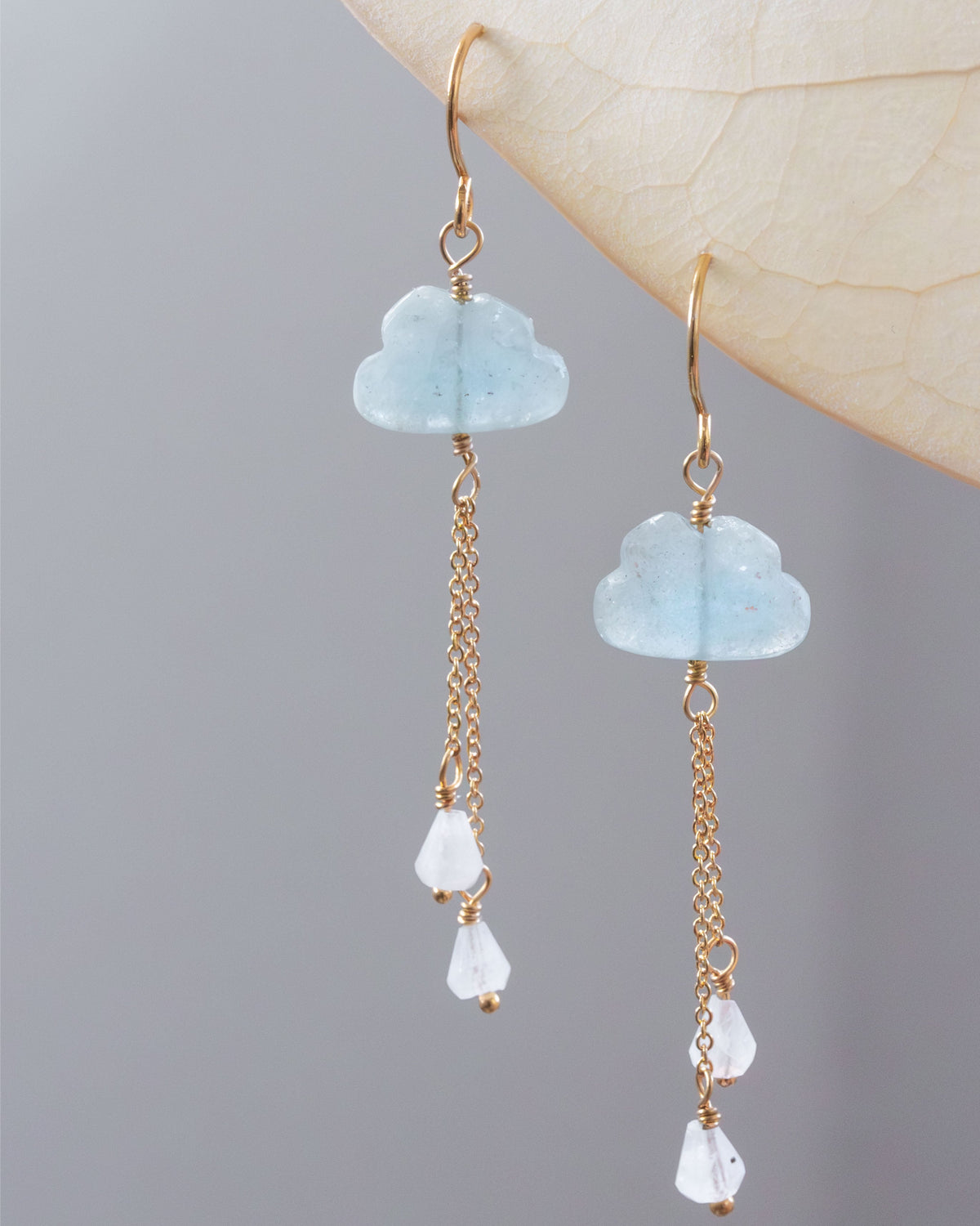 Aquamarine cloud-shaped earrings with gold chains and white moonstone rain drop stones