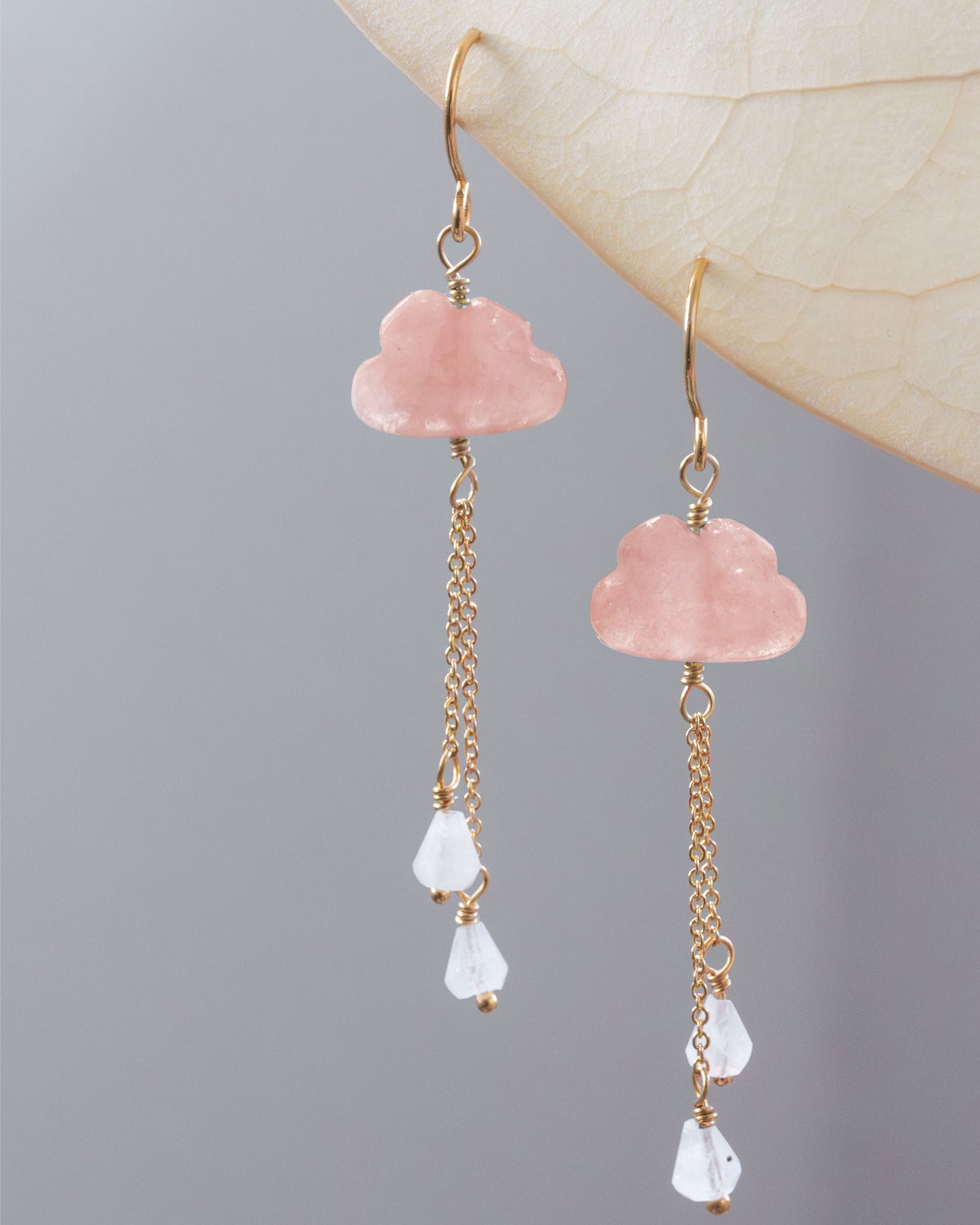 Pair of pink opal cloud-shaped earrings with gold chains and white moonstone beads