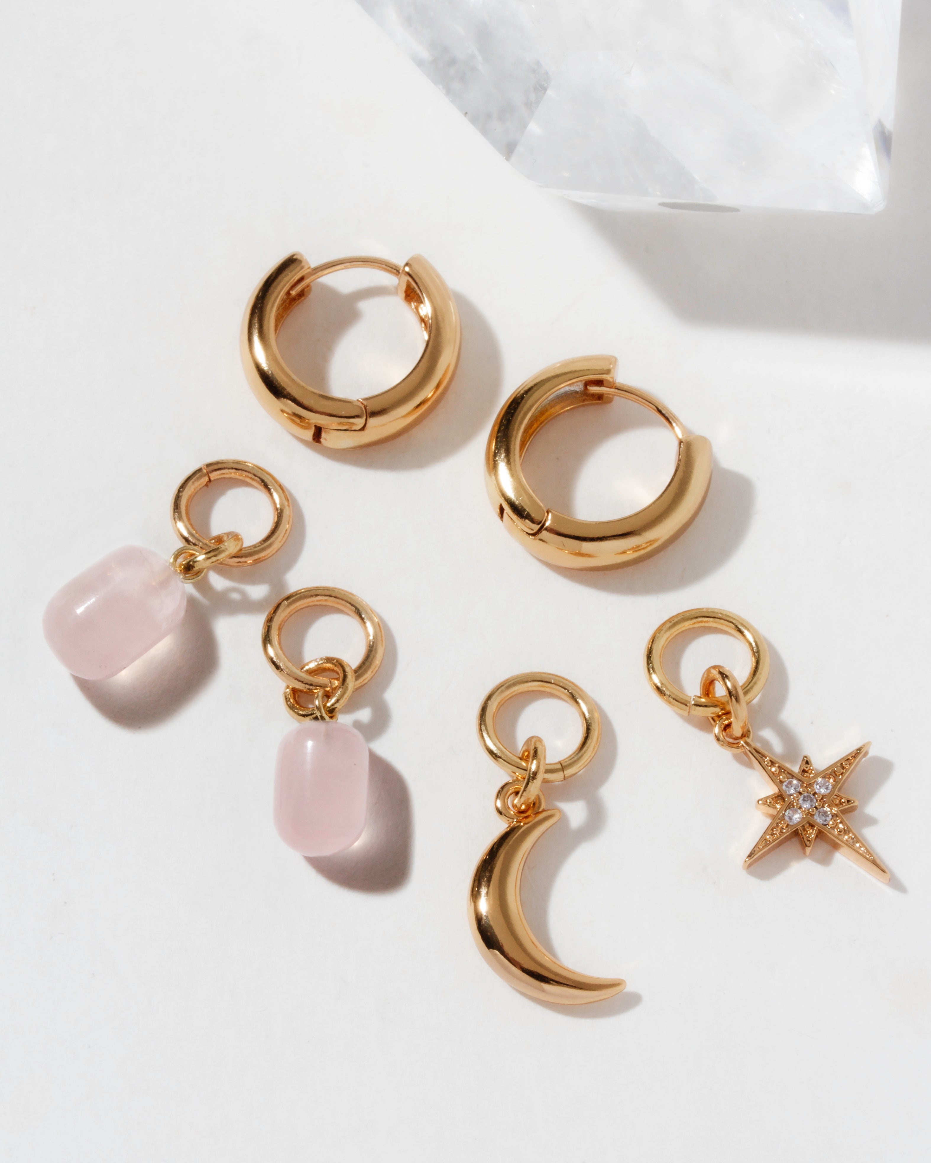 Constella hoop set with rose quartz drops, gold moon, and jeweled North Star charms