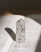 A mini tourmalinated quartz tower with dark inclusions