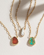 Three Elemental Force Necklaces: Coffee Moonstone, Freshwater Pearl, and Turquoise.