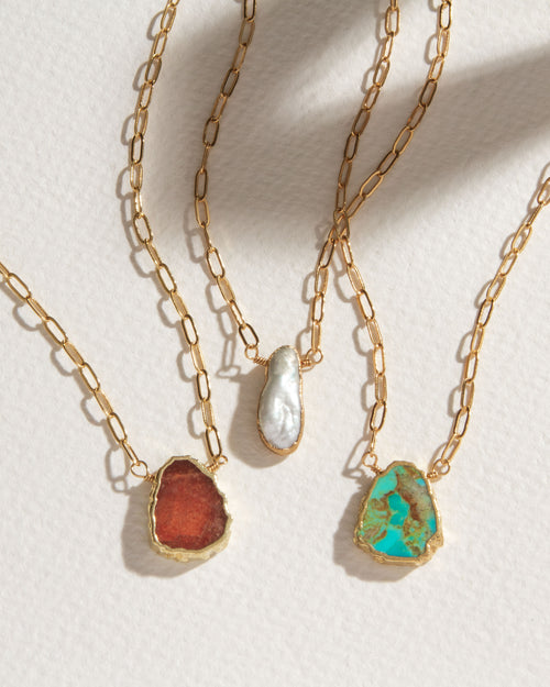 Three Elemental Force Necklaces: Coffee Moonstone, Freshwater Pearl, and Turquoise.