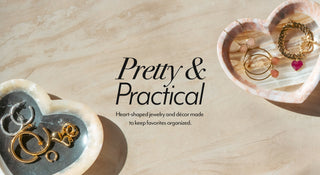 Heart-shaped jewelry organizers with jewelry on a stone surface, featuring text 'Pretty & Practical, heart-shaped jewelry and decor made to keep favorites organized"