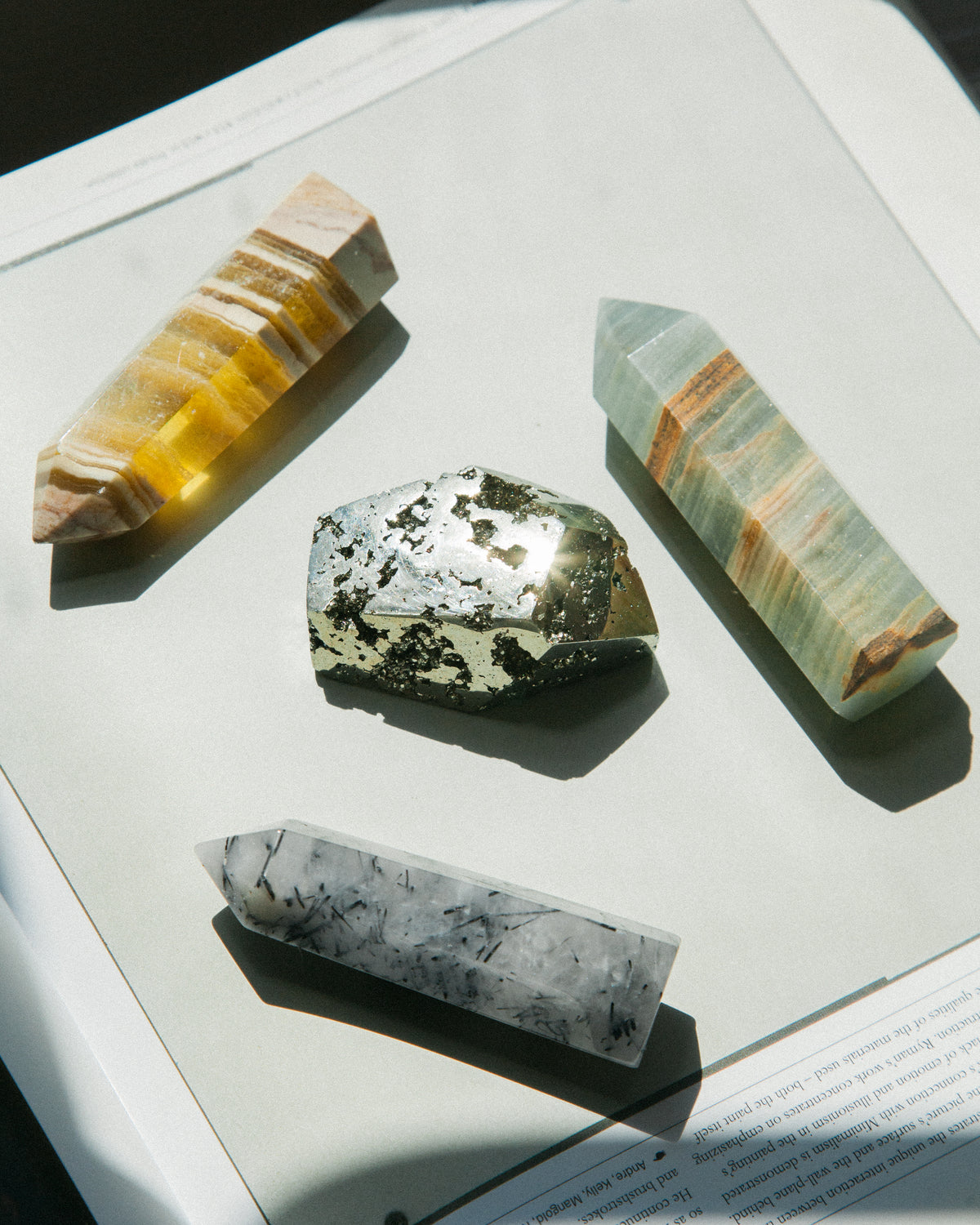Four various gemstone towers are shown on a book.