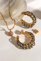 Golden Eclipse Vertebrae Post Hoop Earrings and gold pendant necklace with blush-colored gem