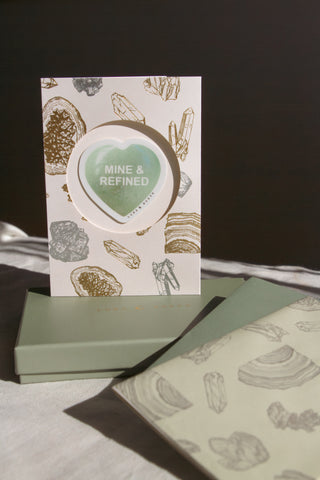 Green Luna Norte box with a card featuring 'MINE & REFINED' and gemstone illustrations gift papers.