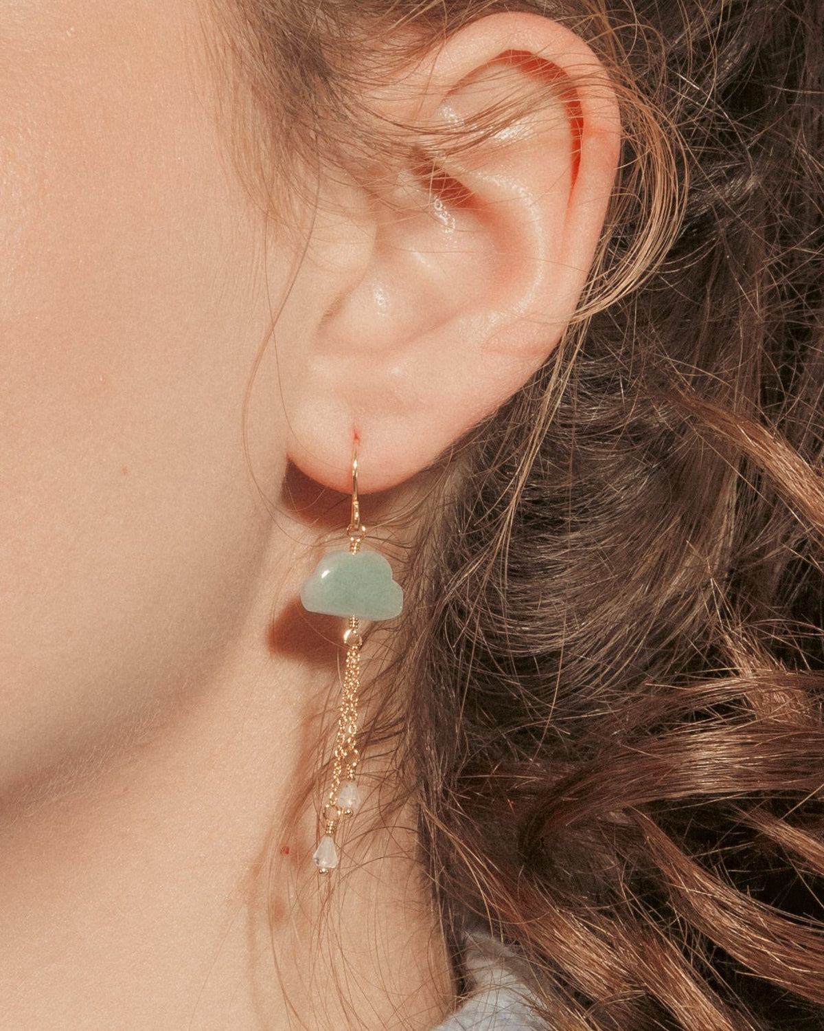 A model wearing aquamarine cloud drop earring.