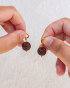 Gold hoops, one with a colorful druzy sphere charm