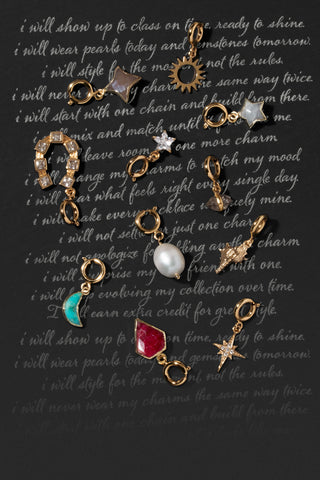Various gemstone charms overlayed a chalkboard background
