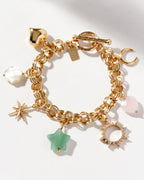 Gold-plated charm bracelet with charms with a heart, a flower, a star, and gem beads.