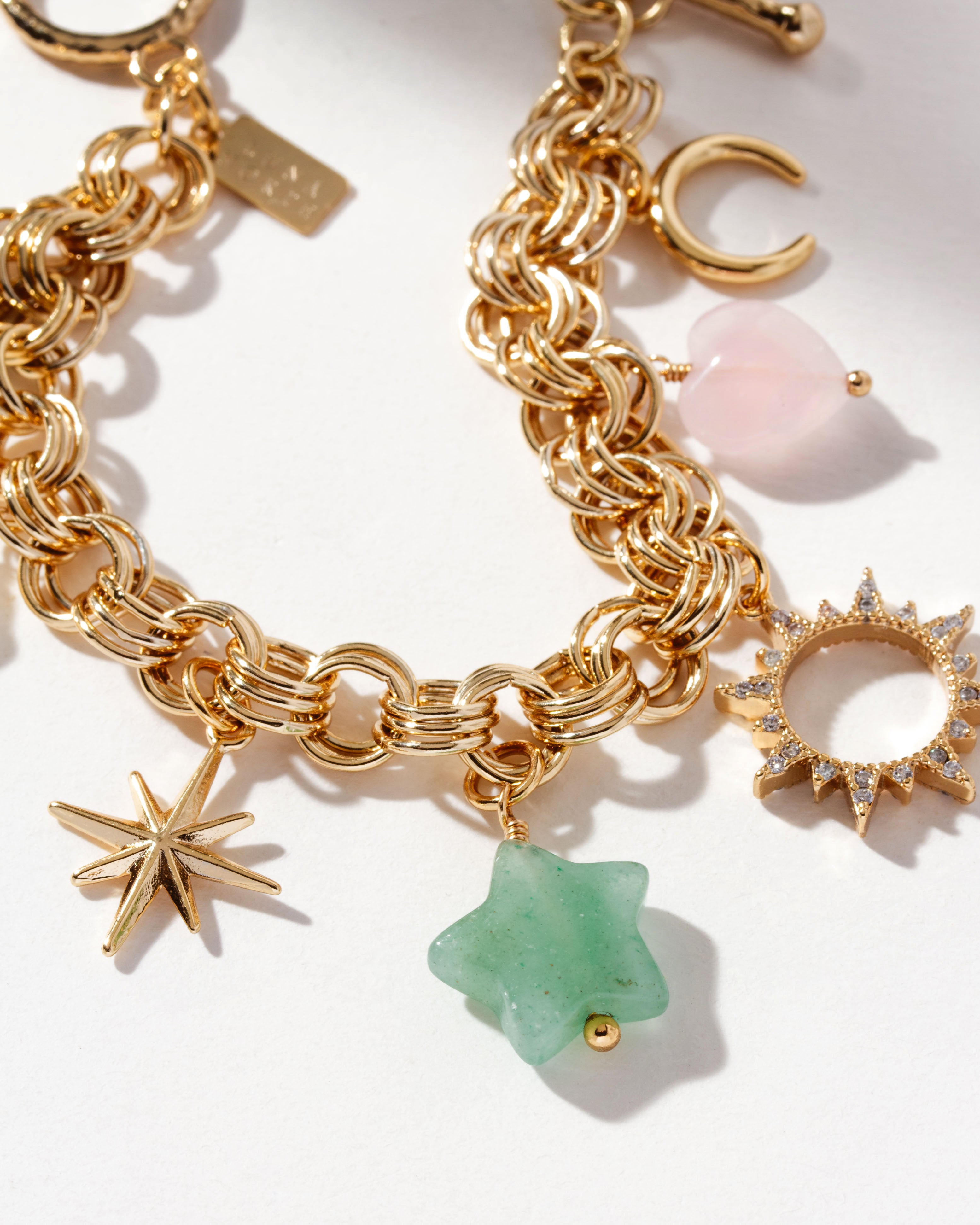 Gold-plated bracelet with a heart, a flower, a star charms, and gem beads.