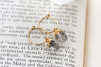 Gold hoop earrings with raw, rough-cut clear Herkimer quartz gemstones.