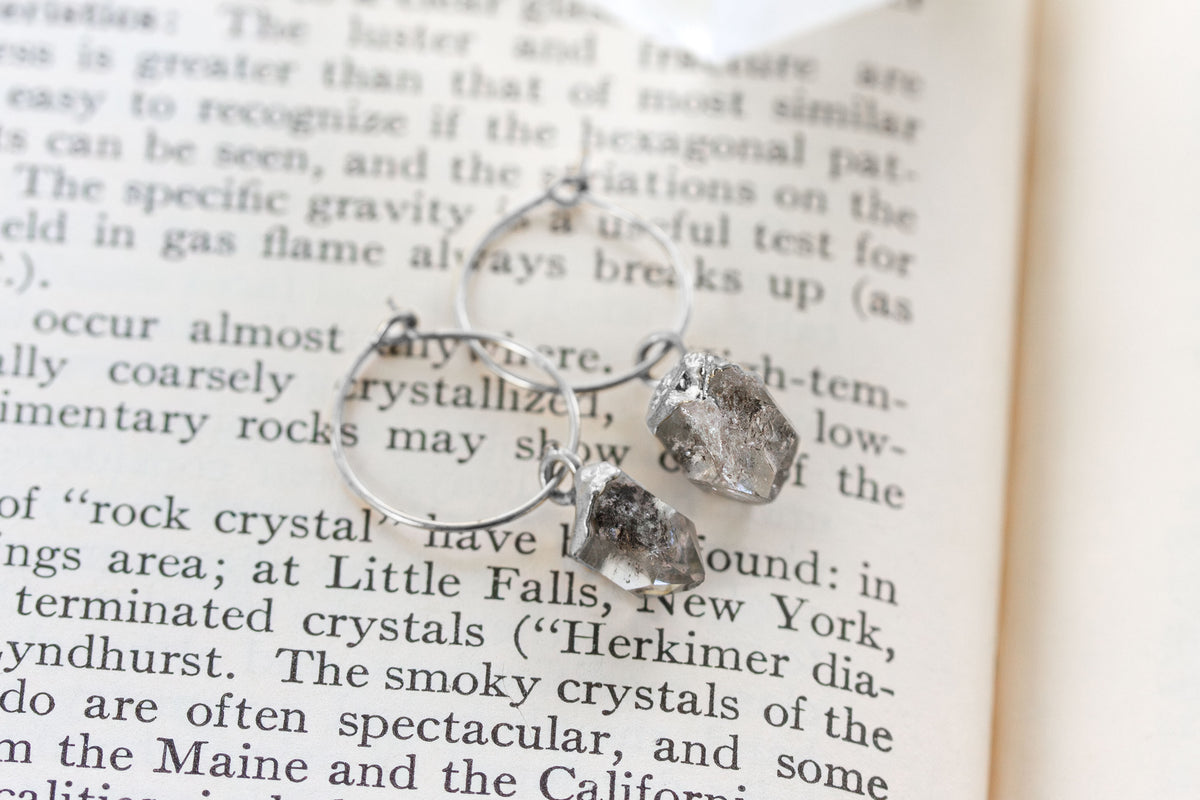 Silver hoop earrings with rough, irregular Herkimer quartz clear crystal charms.