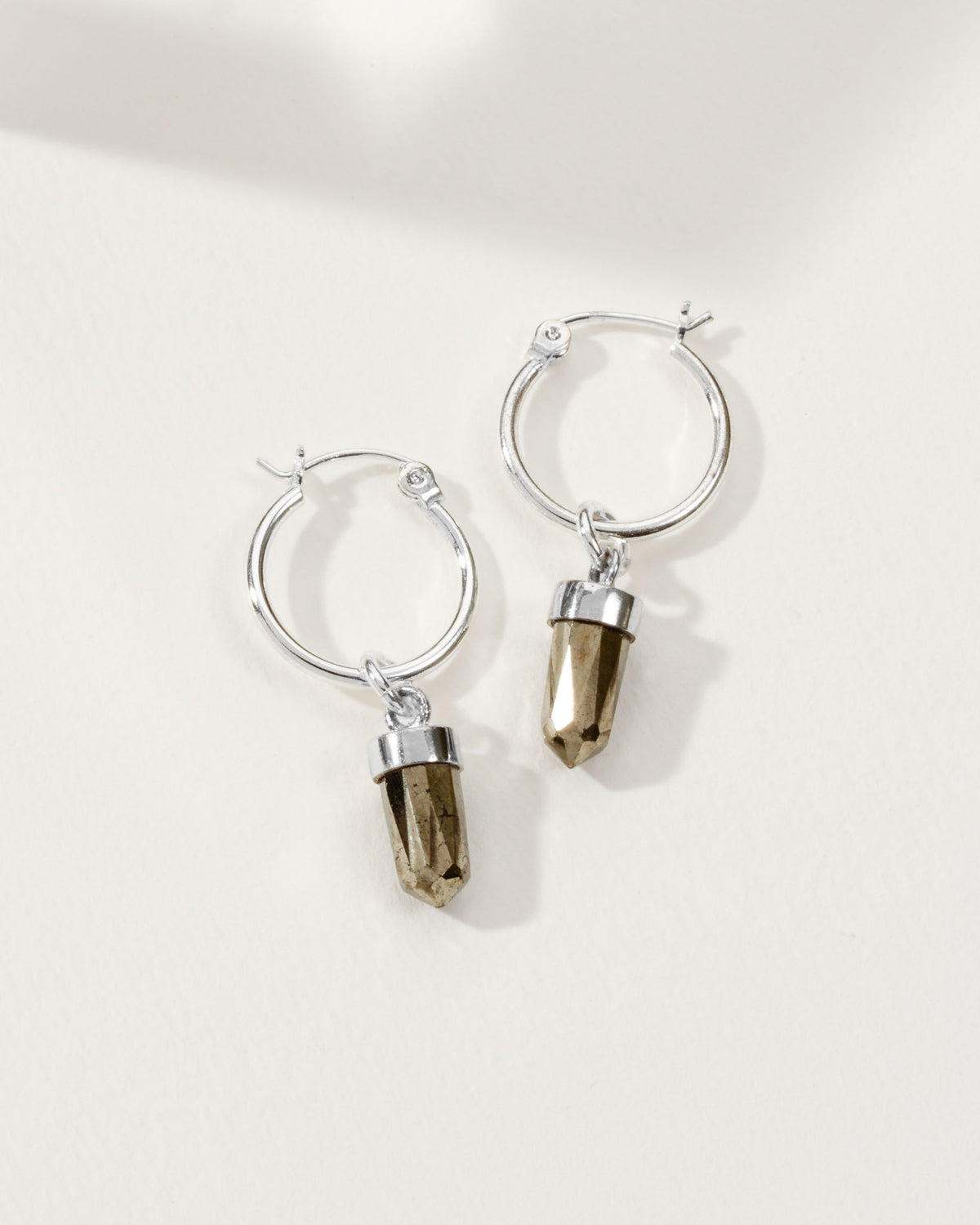 Silver hoop earrings with pyrite charms.