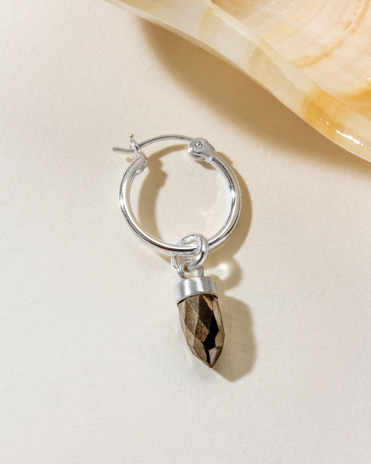 On Point Solo Hoop Earring Silver with a Pyrite charm detail.