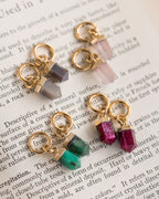 Several pendant charms on a book page.