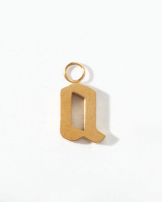 Gold letter 'q' charm on a white background