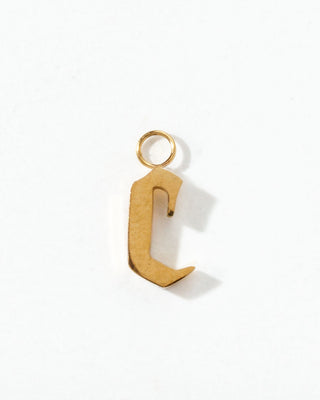 Gold letter 'C' charm on a white background