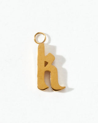 Gold letter 'K' charm on a white background