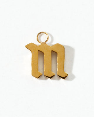 Gold letter 'm' pendant on a white background