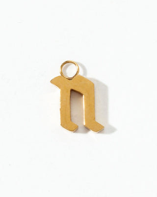 Gold letter 'n' pendant on a white background