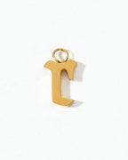 Gold letter "r" charm on a white background.