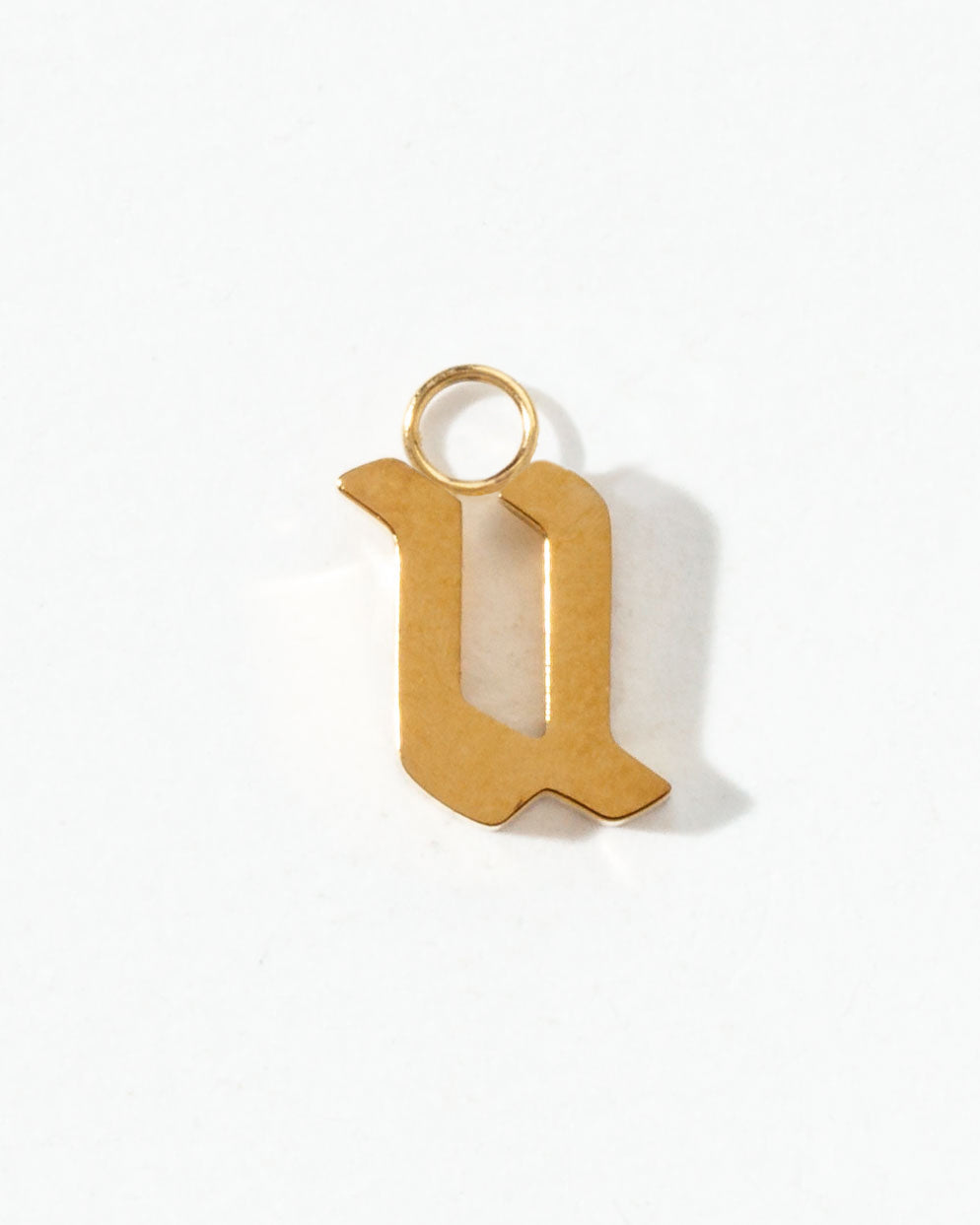 Gold letter 'u' pendant on a white background