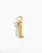 Gold letter "i" charm on a white background.