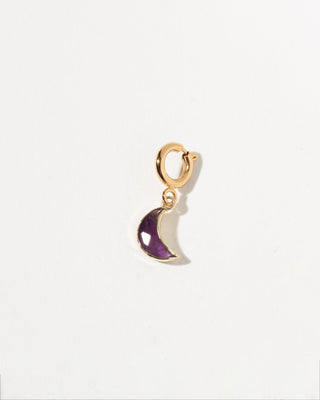 Gold amethyst half-moon charm on a white background