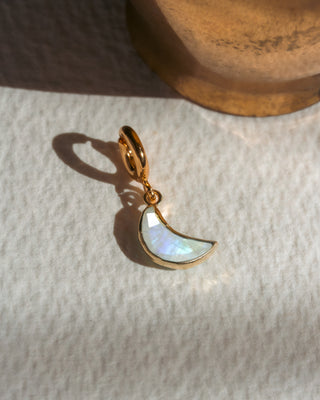 Gold crescent moon charm in white moonstone