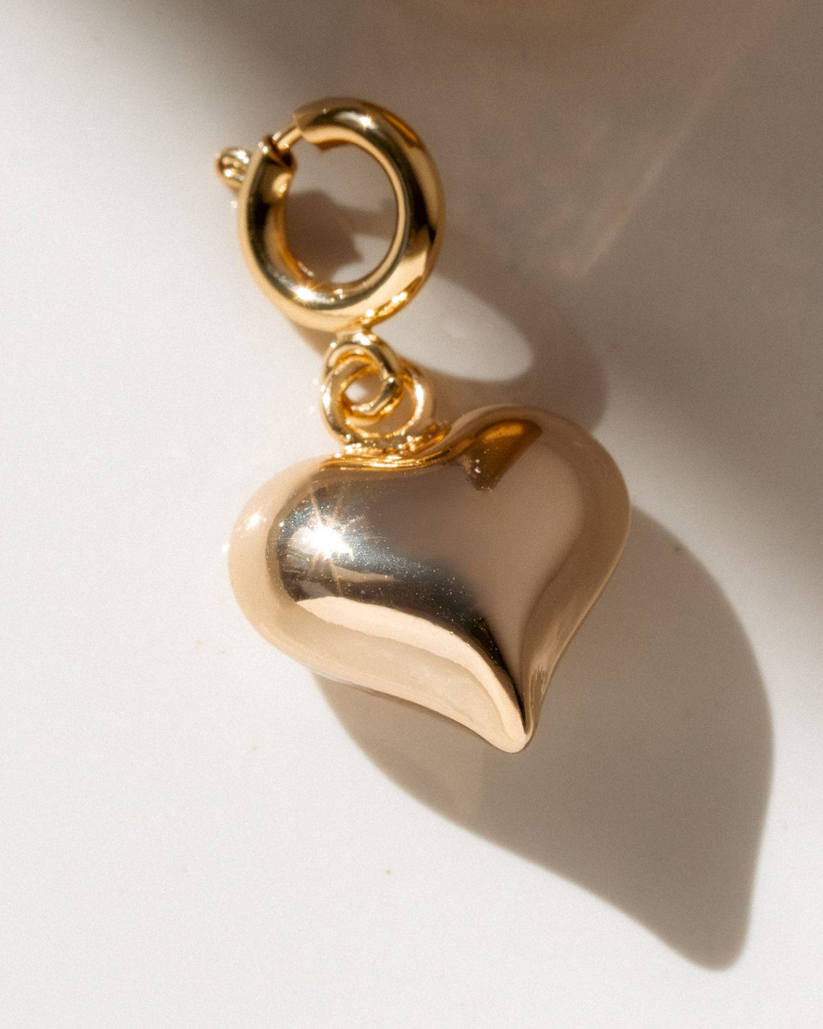Gold heart-shaped charm on a light background