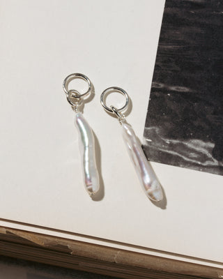 Silver-plated elongated pearl-shaped earring charms.
