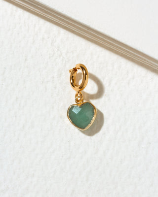 A small gold heart-shaped charm with a faceted green aventurine stone, attached to a gold c-clasp.